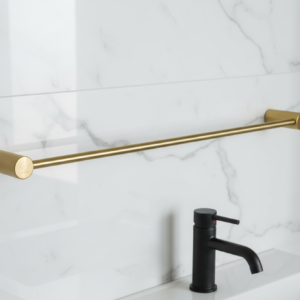 Gold towel bar mounted on a marble tiled wall with a black faucet.