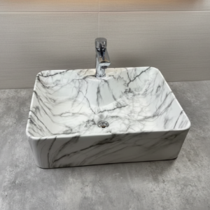 Marble-patterned square sink on a gray surface